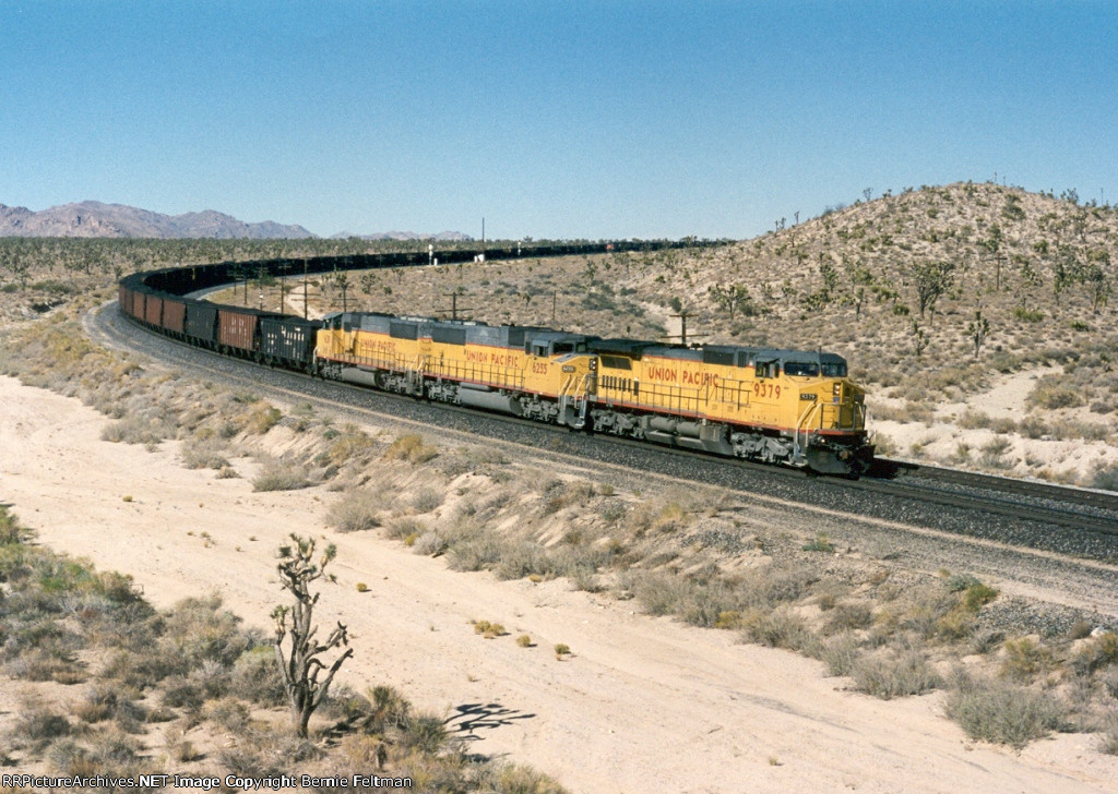 Union Pacific C40-8W #9379 (with SD60M's 6255 & 6311), in full dynamic braking, begins its slow descent down Cima Hill with a loaded coal train 